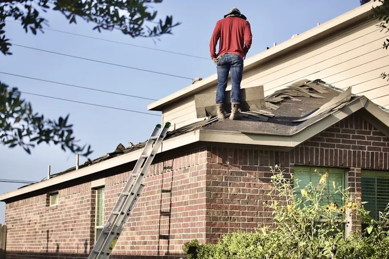 Professional roofer working on a residential roof in Villas